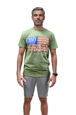 Load image into Gallery viewer, Man wearing a green We The People t-shirt with a graphic design on a plain background
